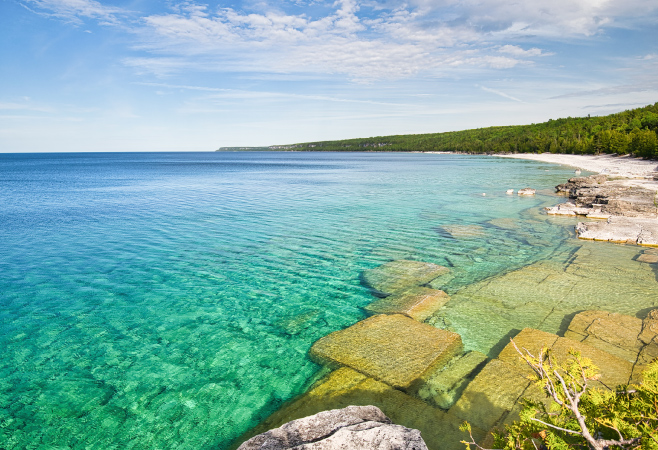 Half Log Dump is on the Bruce Peninsula, a former lumber dump, now a hiking spot with rocky terrain, beaches, and views of turquoise water.