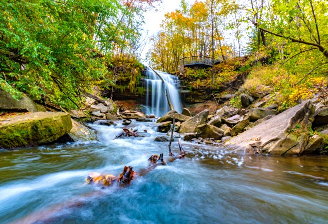 Smokey Hollow Waterfall, also known as Grindstone Falls, is a hidden gem in Hamilton, offering a peaceful retreat.