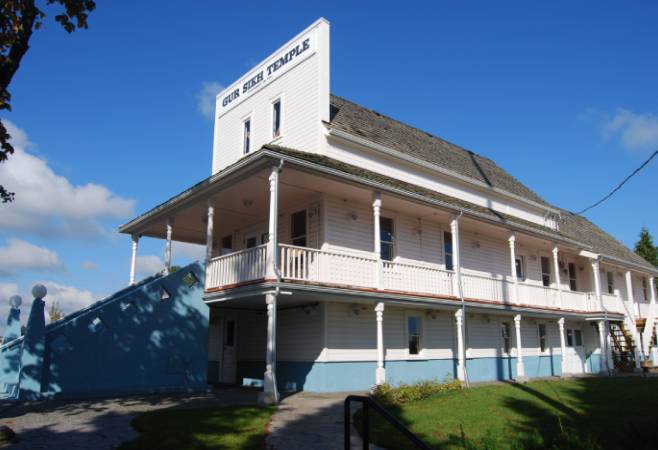 The Gur Sikh Temple is a simple rectangular, gable-roofed building of wood- frame construction with a false-front facade that faces the street. The Gur Sikh Temple is a simple rectangular, gable-roofed building of wood- frame construction with a false-front facade that faces the street.